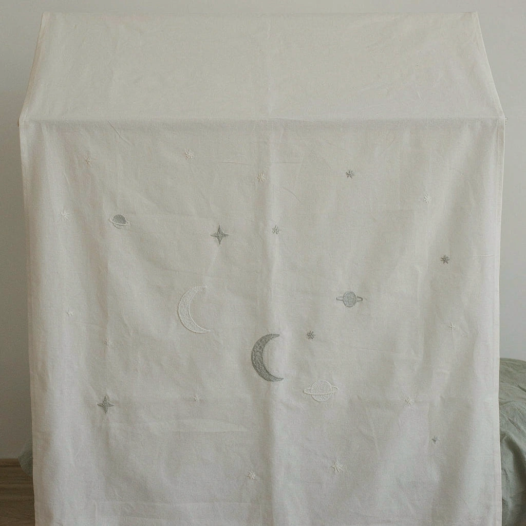 Voile de lit enfant écru brodé de lunes et d'étoiles au-dessus d'un lit